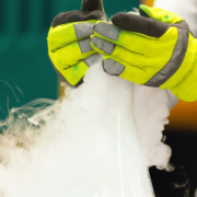 a person with gloves on handling dry ice safely